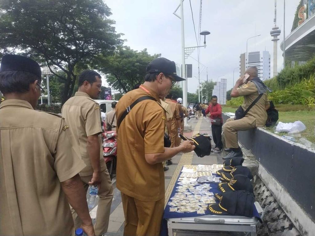 Para pedagang atribut kepala desa memanfaatkan momen untuk berdagang di kawasan Senayan Park, Jakarta Pusat, Selasa (17/1/2023).