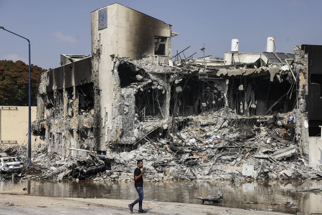 A man walks past the Israeli police station in Sderot that was damaged during the battle to expel Hamas fighters inside on October 8, 2023.