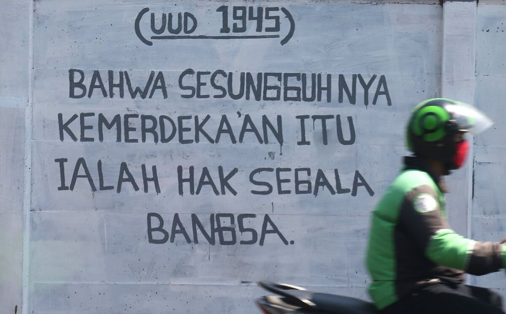Mural yang berisi salah satu petikan Pembukaan Undang-Undang Dasar (UUD) 1945 tergambar di Jalan Raya Bogor, Depok, Jawa Barat, Rabu (28/7/2021). 
