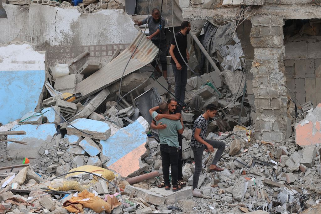 Warga Palestina mencari korban yang selamat di bawah reruntuhan rumah yang hancur akibat serangan udara Israel di Rafah di Jalur Gaza selatan, Senin (9/10/2023). 