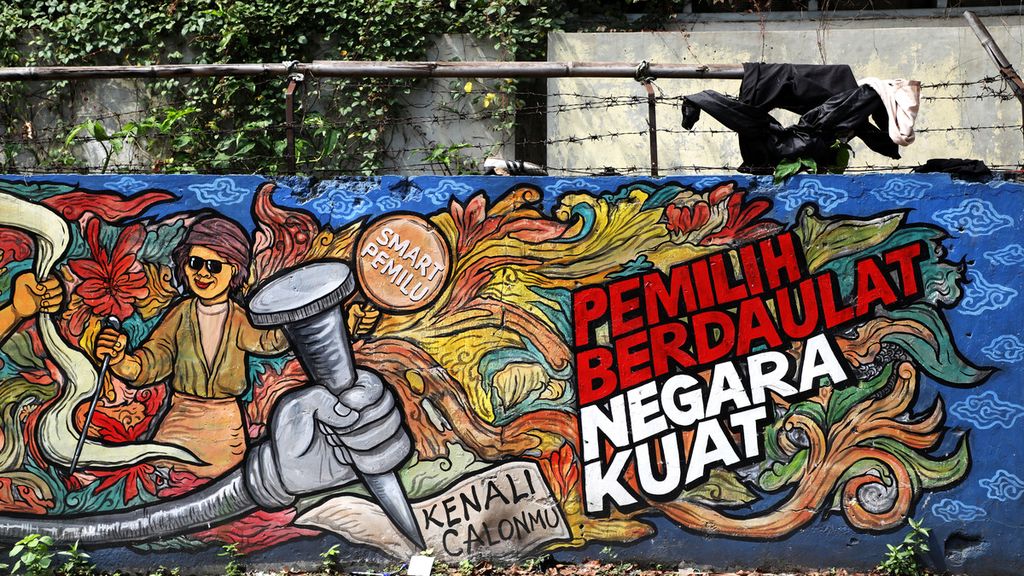 Mural tentang pemilihan umum yang diinisiasi Komisi Pemilihan Umum di pagar tembok di Jalan Kebon Jahe, Kota Tangerang, Rabu (25/3/2020). 