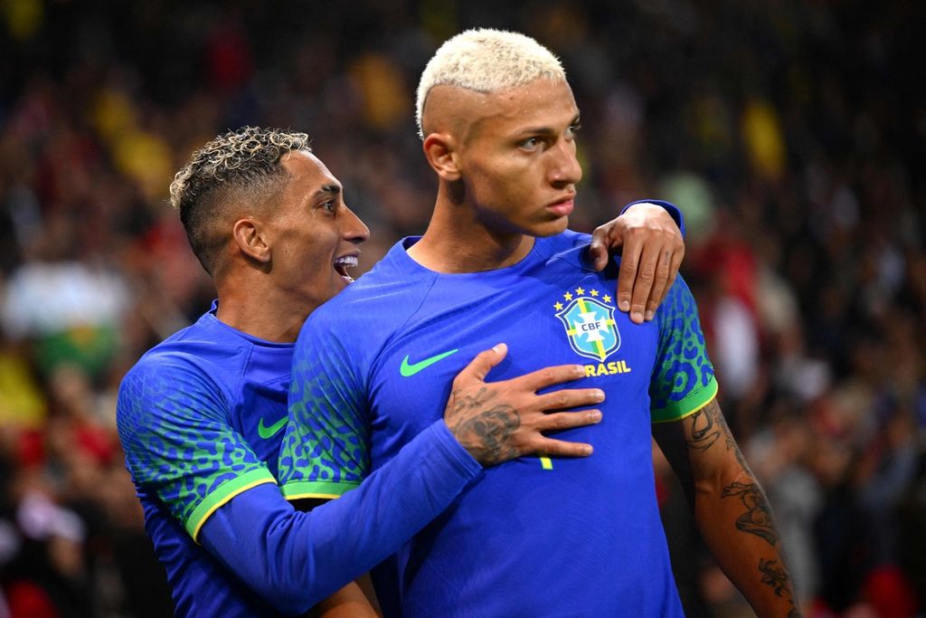 Pemain timnas Brasil Richarlison (kanan) merayakan gol kedua bagi timnya laga persahabatan di Stadion Parc des Princes, Paris, (Selasa (27/9/2022). Richarlison mengalami penghinaan rasis saat merayakan golnya tersebut. Laga itu dimenangi Brasil dengan skor 5-1. Richarlison terpaksa batal memperkua timnas Brasil di Piala Dunia 2022 karena cedera betis setelah laga Liga Inggris antara Tottenham Hotspur dan Everton, Minggu (16/10/2022).