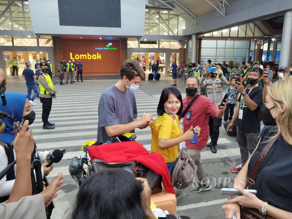 Salah seorang pebalap memberikan tanda tangan ke penggemarnya saat tiba di Bandara Internasional Lombok, Rabu (16/3/2022). Seluruh pebalap yang akan tampil dalam ajang MotoGP, Moto2, Moto3, dan Idemitsu Asia Talent Cup telah tiba di Lombok.