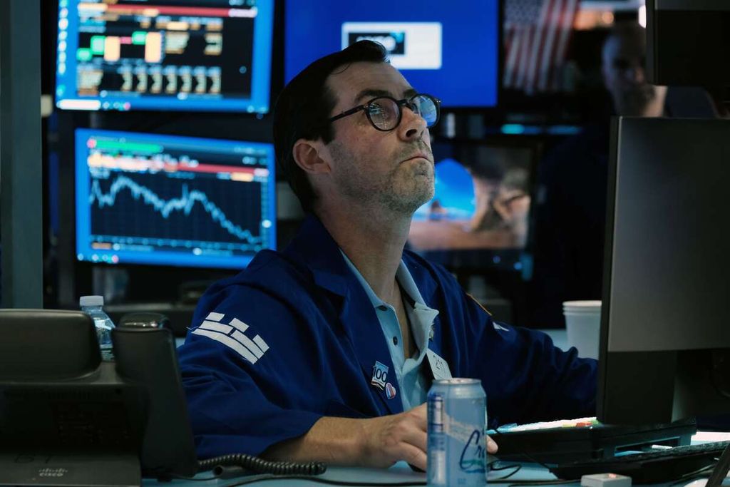 Seorang <i>trader </i>bekerja di New York Stock Exchange (NYSE), Amerika Serikat, Jumat (26/8/2022).