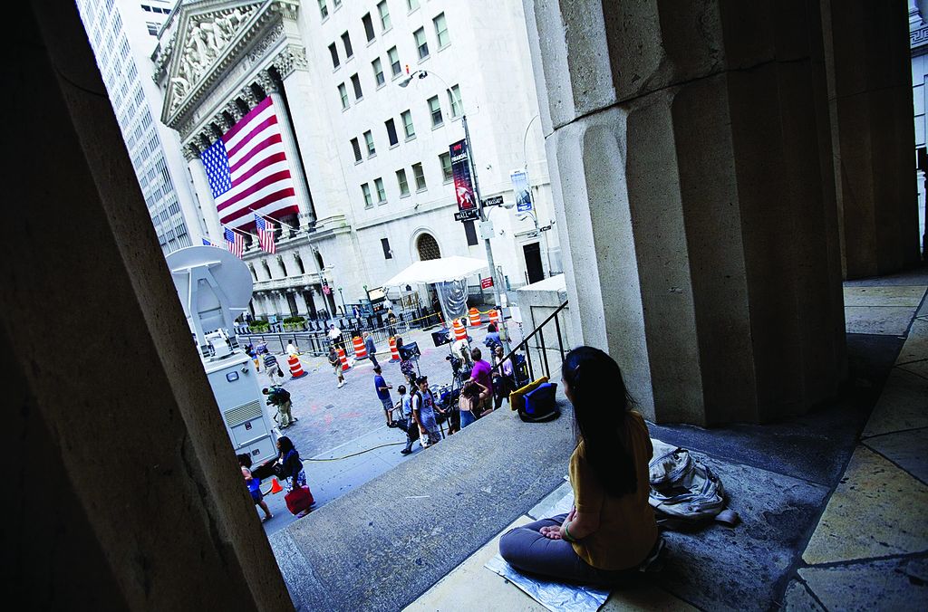 CORRECTS FOR MONDAY, NOT WEDNESDAY - A woman meditates on the steps of Federal Hall near the New York Stock Exchange on Monday, Aug. 8, 2011, in New York. All signs point to a sharp decline when trading begins in U.S. markets this morning. Overnight, international markets fell amid anxiety overthe European debt crisis, Standard & Poor\'s downgrade of U.S. long-term debt late Friday and concerns about the U.S. economy. (AP Photo/Jin Lee)