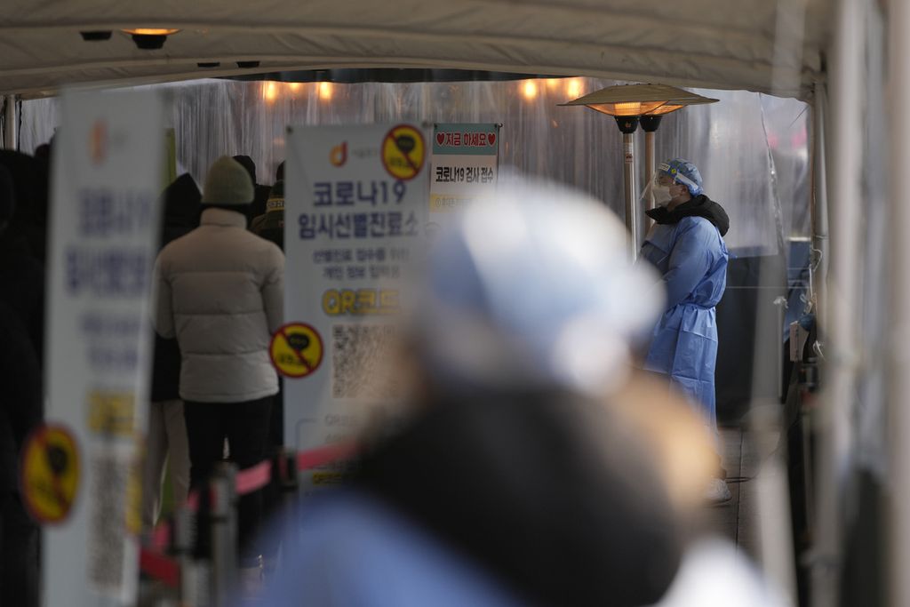 Petugas kesehatan membantu seorang warga yang ingin melakukan tes Covid-19 di Balai Kota Pemerintah Kota Seoul, Rabu (26/1). Kasus Covid-19 di negara ini dalam 24 jam terakhir sebanyak 13.000-an kasus, rekor tertinggi sejak kasus pertama ditemukan pada pertengahan pada Januari 2020. 