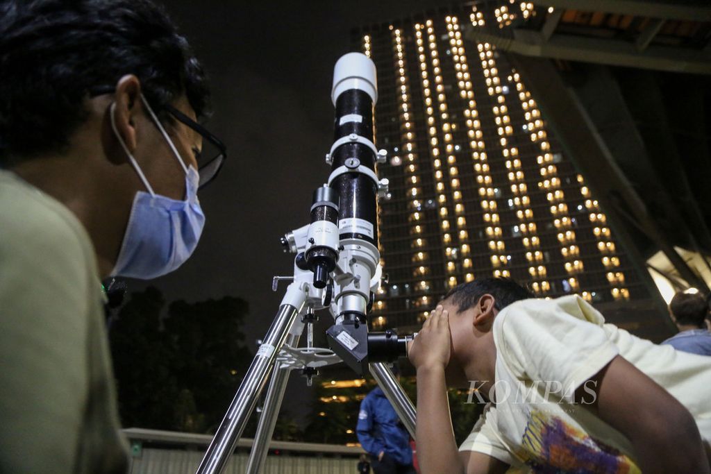 Petugas mengajarkan anak melihat benda langit dengan menggunakan teleskop di Taman Ismail Marzuki, Jakarta, Selasa (24/10/2023). 