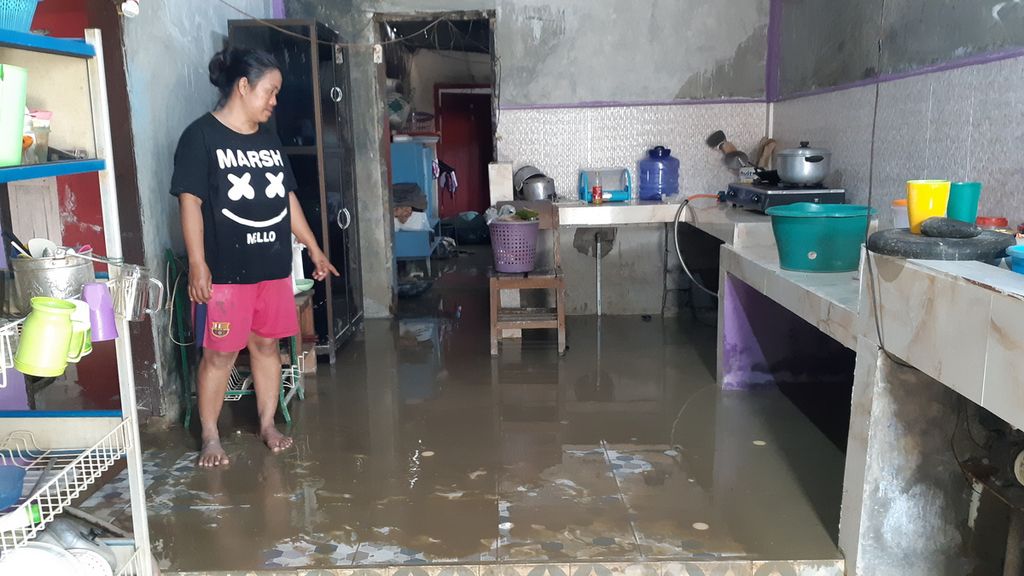 Rini (38), warga Kelurahan Ujuna, Kecamatan Palu Barat, Kota Palu, Sulawesi Tengah, berada di dapurnya yang tergenang air bercampur lumpur pada Rabu (7/9/2022). Banjir akibat luapan Sungai Palu pada Selasa (6/9/2022) sudah surut, warga mulai Rabu pagi membersihkan rumah mereka dari air bercampur lumpur.
