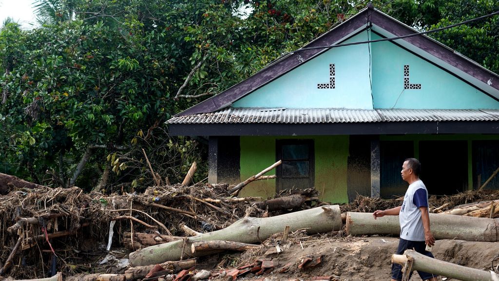 Ilustrasi - Warga melintasi sisa-sisa sapuan banjir bandang di Desa Kalong Sawah, Jasinga, Bogor, Selasa (7/1/2020). Longsor di hulu Sungai Cidurian yang menimbulkan banjir bandang Rabu (1/1/2020) juga menerjang wilayah Jasinga ini. 