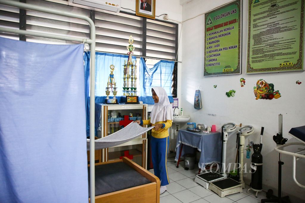 Siswa yang menjadi dokter cilik merapikan ruang usaha kesehatan sekolah (UKS) di SD Negeri Bendungan Hilir 01 Pagi, Jakarta Pusat, Kamis (12/3/2020). Edukasi menjaga kebersihan diri, seperti mencuci tangan yang benar dan mengintensifkan fungsi UKS, merupakan upaya pihak sekolah dalam mengantisipasi wabah Covid-19. 
