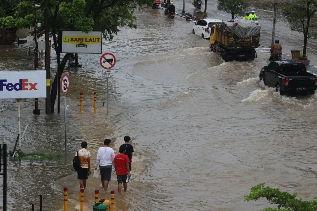 Banjir merendam ruas Jalan Basuki Rahmat, Palembang, Sumatera Selatan, Sabtu (25/12/2021). Banjir disebabkan oleh meningkatnya curah hujan dan meluapnya anak Sungai Musi.