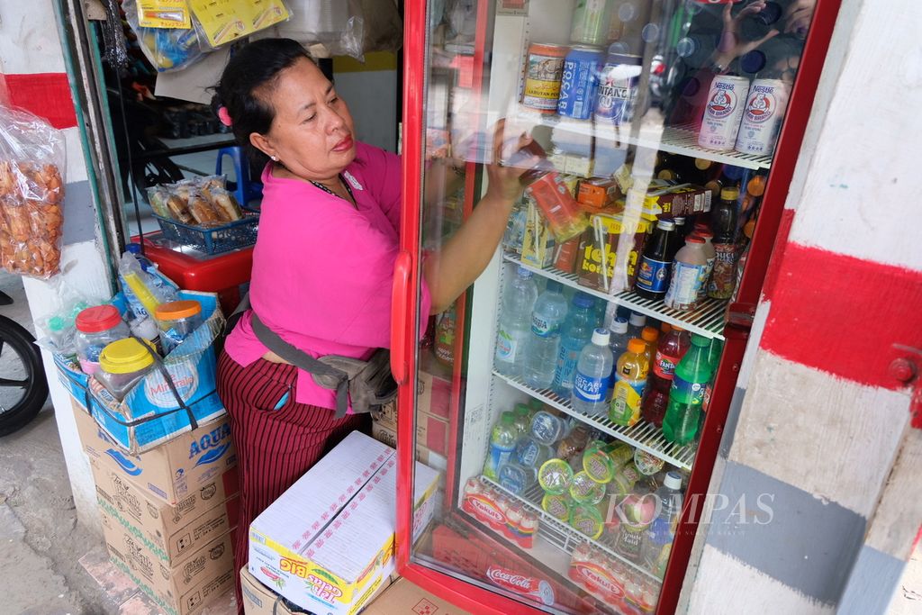 Seorang pedagang usaha mikro tengah menjual minuman teh kemasan kepada pembeli di Jakarta, Senin (9/3/2020). Terkait wacana pemerintah untuk mengenakan pajak terhadap minuman berpemanis, pedagang berharap agar pajak tersebut tidak memberatkan usaha mereka.