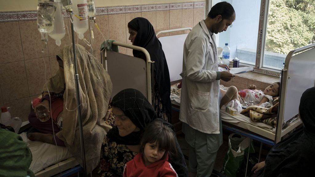 Seorang dokter memeriksa anak-anak saat orangtua dan pasien duduk di ruangan yang sesak di Indira Gandhi Childrens Hospital di Kabul, Afghanistan, 5 Oktober 2021. 