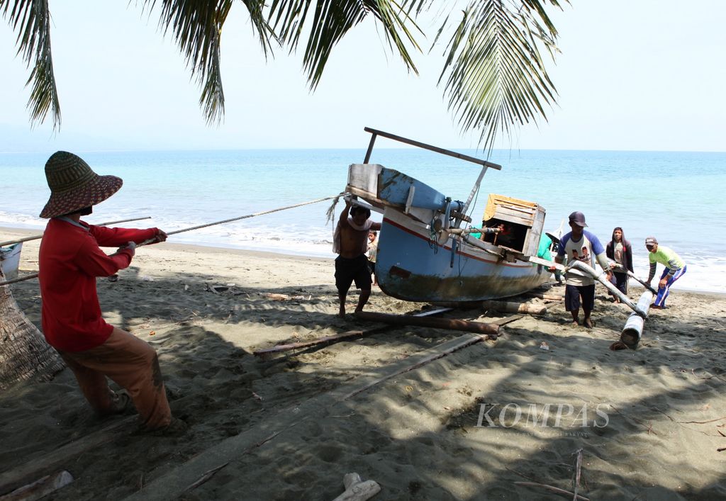 Para nelayan di Pantai Tappalang, Kabupaten Mamuju, Sulawesi Barat, bergotong-royong menambatkan perahu seusai melaut, Selasa (26/7/2011).