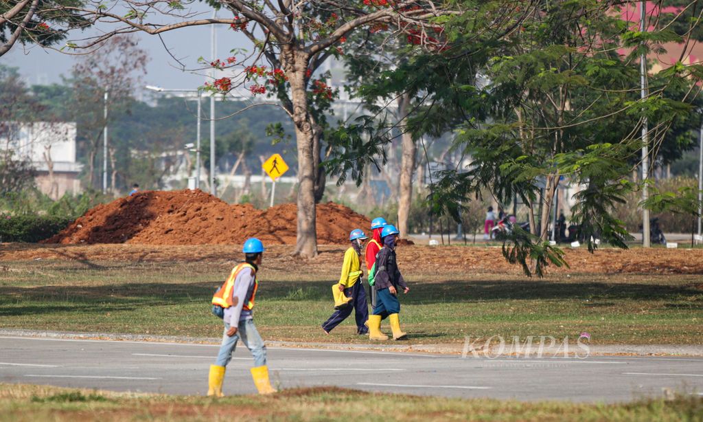 Para pekerja konstruksi berjalan menuju proyek pembangunan hunian vertikal di kawasan Pinang, Kota Tangerang, Minggu (29/10/2023). Para pekerja luar ruang sangat terdampak cuaca yang memanas.