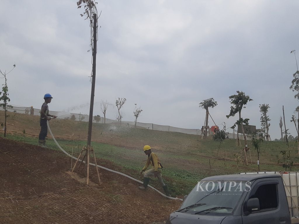Para pekerja menyiram tanaman dan pohon di salah satu sudut area sumbu kebangsaan Ibu Kota Nusantara, Jumat (6/10/2023). Kementerian PUPR mencatat, penataan sumbu kebangsaan sampai akhir September mencapai 72,311 persen.