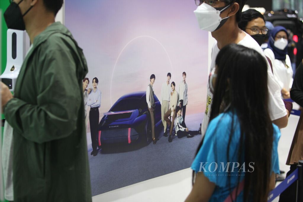 Penggemar kelompok musik Korea Selatan, BTS, antre berfoto di gerai Hyundai dalam pameran otomotif GIIAS 2021 di ICE BSD, Tangerang, Banten pada November 2021