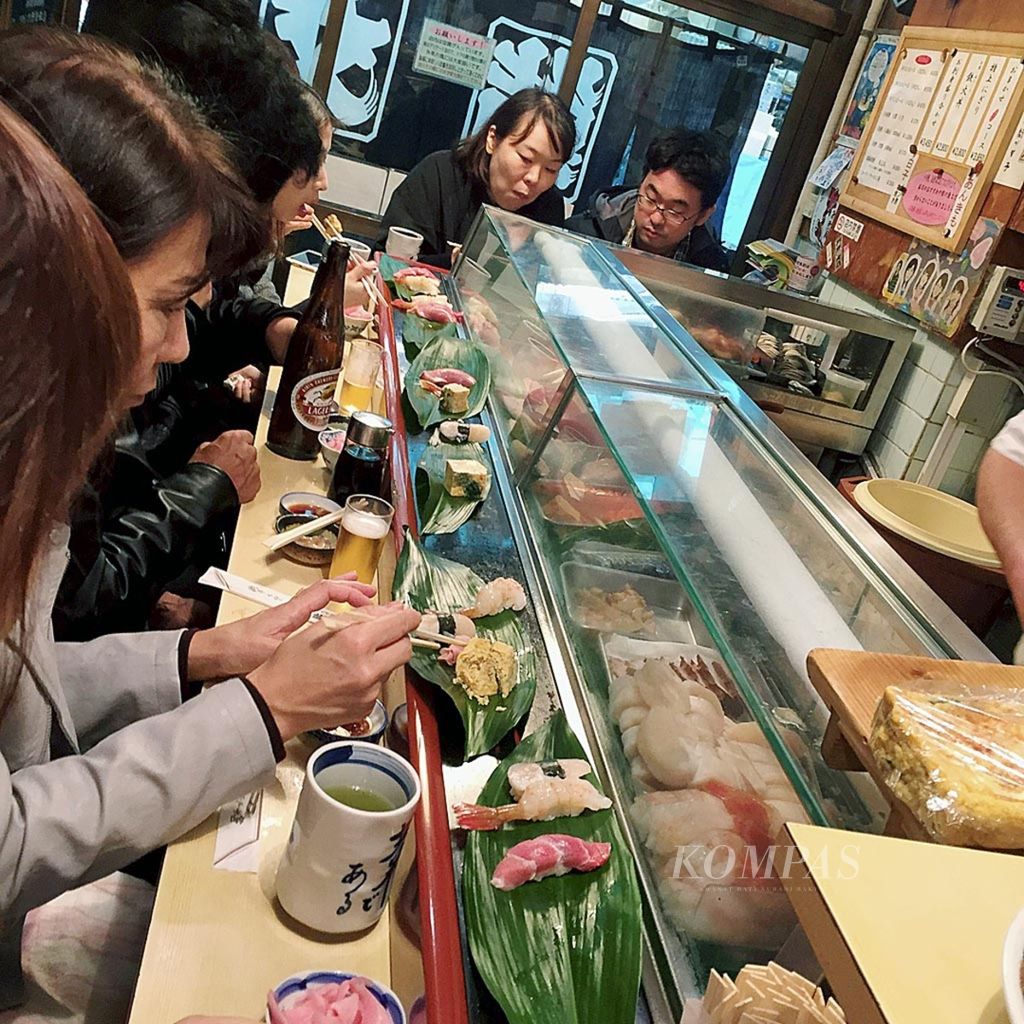 Warung-warung sushi di Pasar Ikan Tsukiji Tokyo hanya menampung 10-12 orang. Para wisatawan harus antre berjam-jam jika ingin menikmati sushi. 