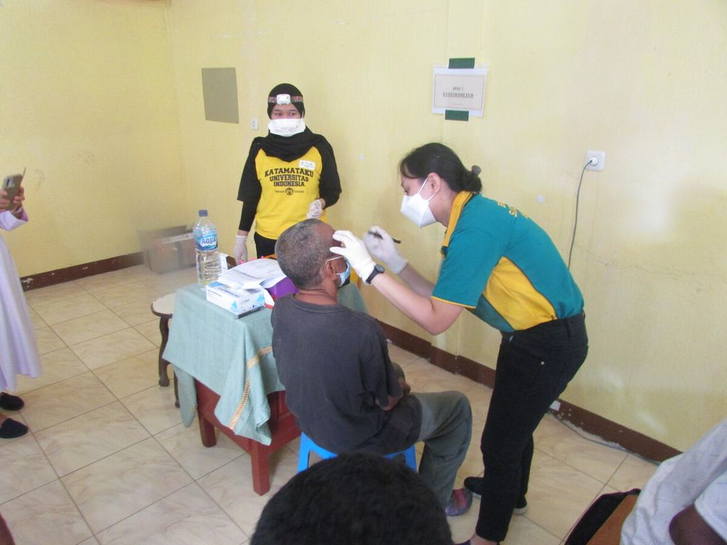  Anggota tim Katamataku sedang memeriksa mata seorang pasien kusta.