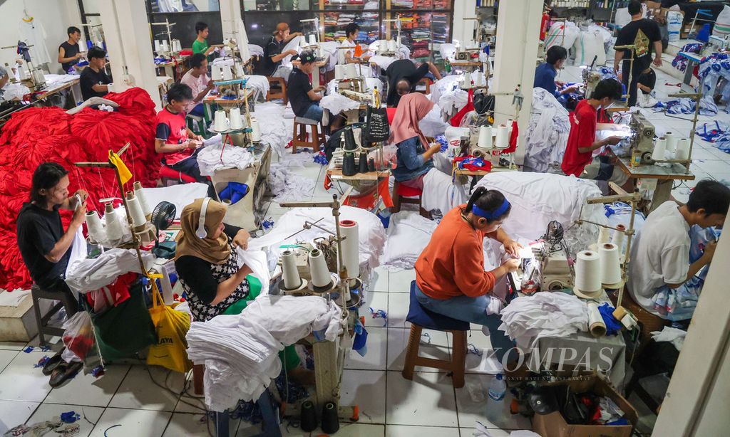 Pekerja menyelesaikan pembuatan kaus partai di sebuah usaha konveksi, di Srengseng Sawah, Jakarta, 27 Oktober 2023.  