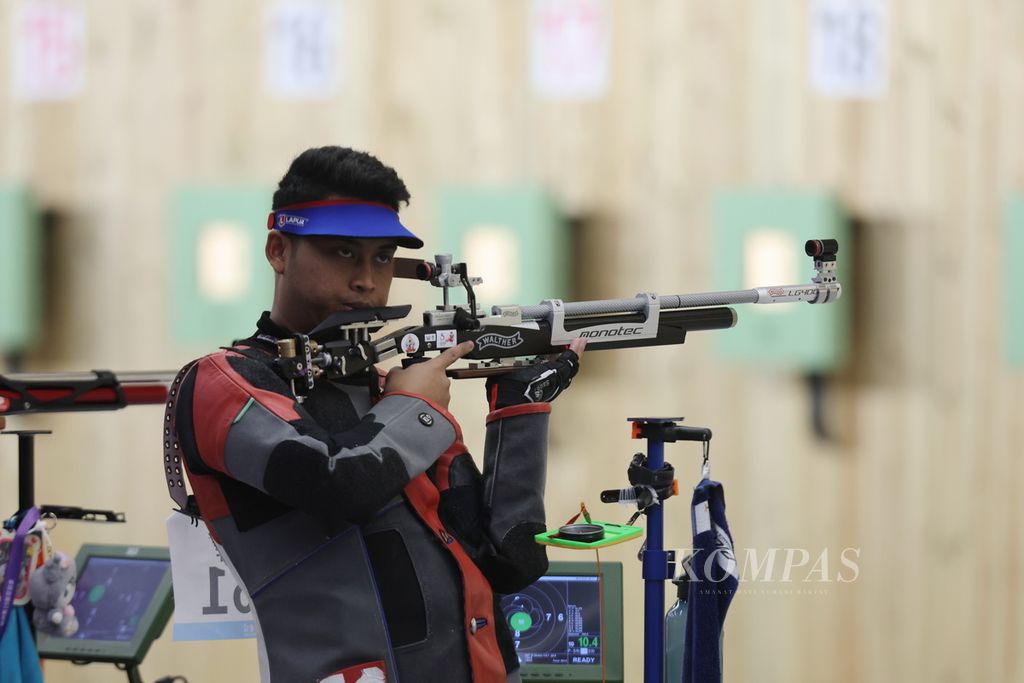 Petembak Indonesia, Fathur Gustafian, yang berpasangan dengan Amelia Sifaul Citra (tidak tampak), bersiap dalam kualifikasi nomor 10 meter <i>air rifle mixed team </i>Asian Games Hangzhou 2022 di Fuyang Yinhu Sports Centre, Hangzhou, China, Selasa (26/9/2023).