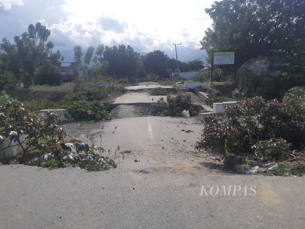 Sepotong jalan raya di Kelurahan Petobo, Kecamatan Palu Selatan, Kota Palu, Sulawesi Tengah, yang kini tak bisa dilewati karena tanahnya ambles akibat gempa dan likuefaksi pada 28 September 2018. Foto diambil pada Jumat (10/1/2020).