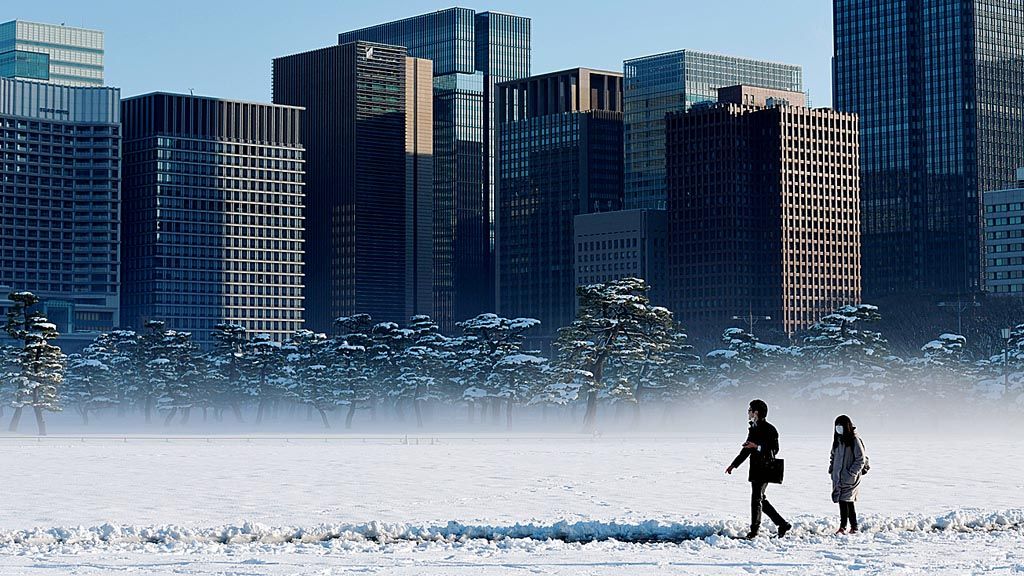 Sementara itu, beberapa warga  Tokyo, Jepang, Selasa (23/1), berjalan melintasi tanah yang tertutup salju. 