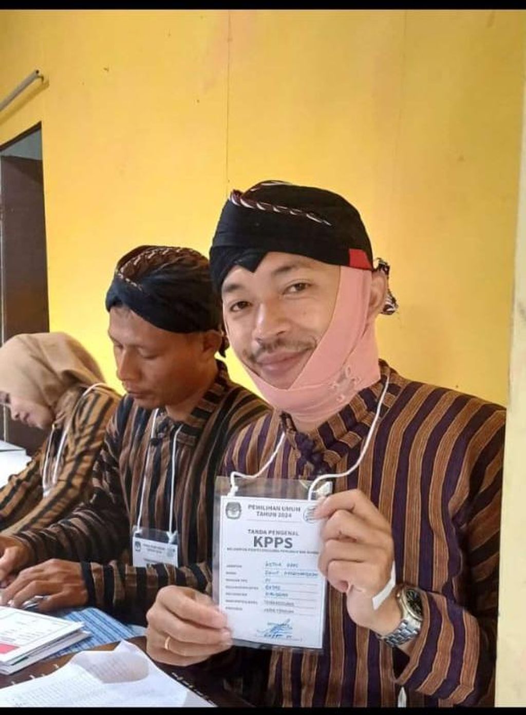 Davit Meriyandoko (32) saat menjalankan tugas sebagai Ketua KPPS di TPS 01 di Dusun Getas, Desa Getas, Kecamatan Kaloran, Kabupaten Temanggung, Rabu (14/2/2024). Davit mengenakan perban di leher dan kepala akibat sendi rahangnya lepas sehingga mulutnya tidak bisa mengatup setelah menguap.