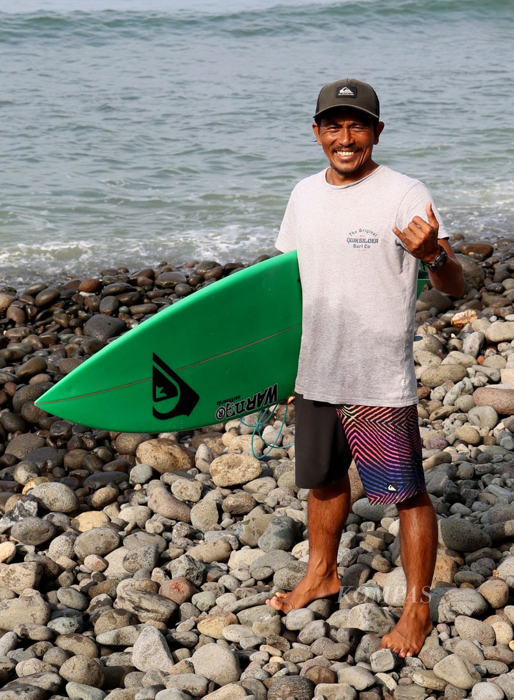 Dede Suryana, a professional surfer from Cimaja, West Java, struck a pose after surfing at Cimaja Beach, Sukabumi Regency, West Java on Wednesday (24/5/2023).