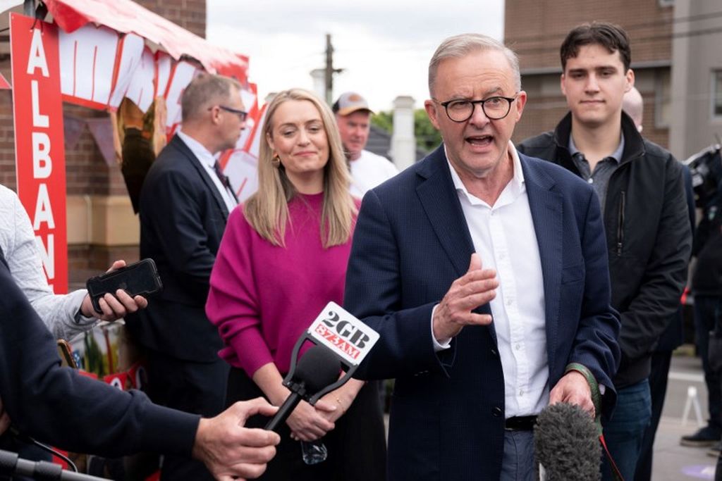 Pemimpin Partai Buruh Anthony Albanese ditemani pasangannya, Jodie Haydon, dan putranya, Nathan Albanese, berbicara kepada media di luar tempat pemungutan suara, di Marrickville, Sydney, 21 Mei  2022. 