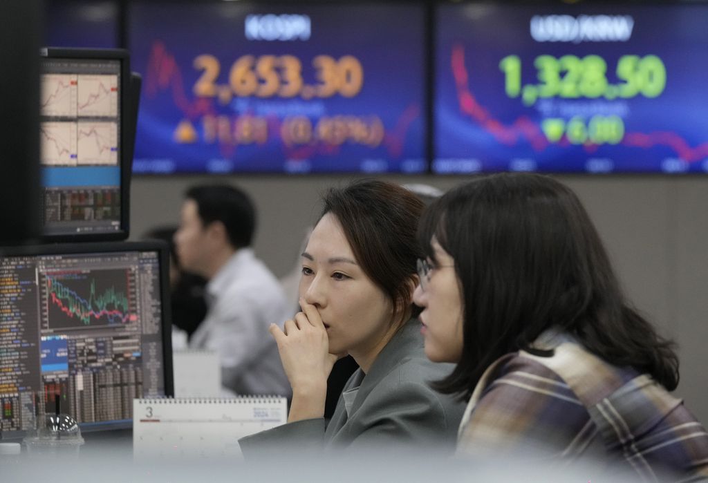 <i>Trader</i> mata uang mengamati layar monitor komputer di ruang pertukaran mata uang asing di kantor pusat KEB Hana Bank di Seoul, Korea Selatan, Kamis (7/3/2024). 