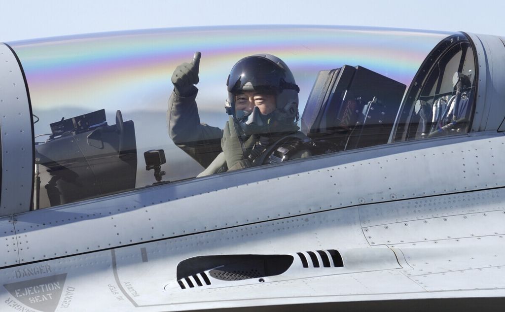 South Korean President Moon Jae-in gives a thumbs-up as he boards a South Korean-made FA-50 jet fighter to attend the the Seoul International Aerospace & Defense Exhibition at the Seoul Military Airport in Seongnam, South Korea, Wednesday, Oct. 20, 2021. The event kicked off on Tuesday for five days with many other affiliated events.