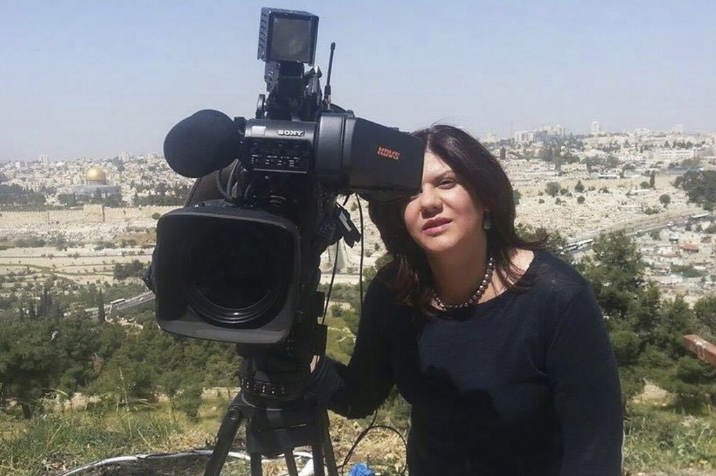 In an undated photo provided by the Al Jazeera media network, Shireen Abu Akleh, a journalist for Al Jazeera, stands next to a TV camera in the area of the Dome of the Rock shrine in the Al-Aqsa Mosque in the Old City of Jerusalem.