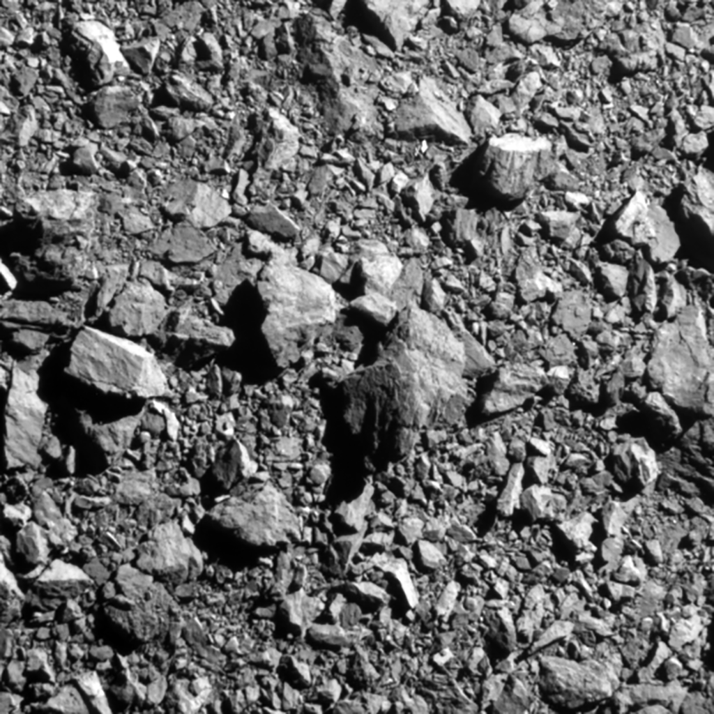 Permukaan asteroid Dimorphos yang diambil dari kamera DRACO yang ada di wahana DART milik NASA. Citra ini diambil pada jarak 12 kilometer dari permukaan Dimorphos atau 2 detik sebelum DART menghantam Dimorphos pada 26 September 2022.