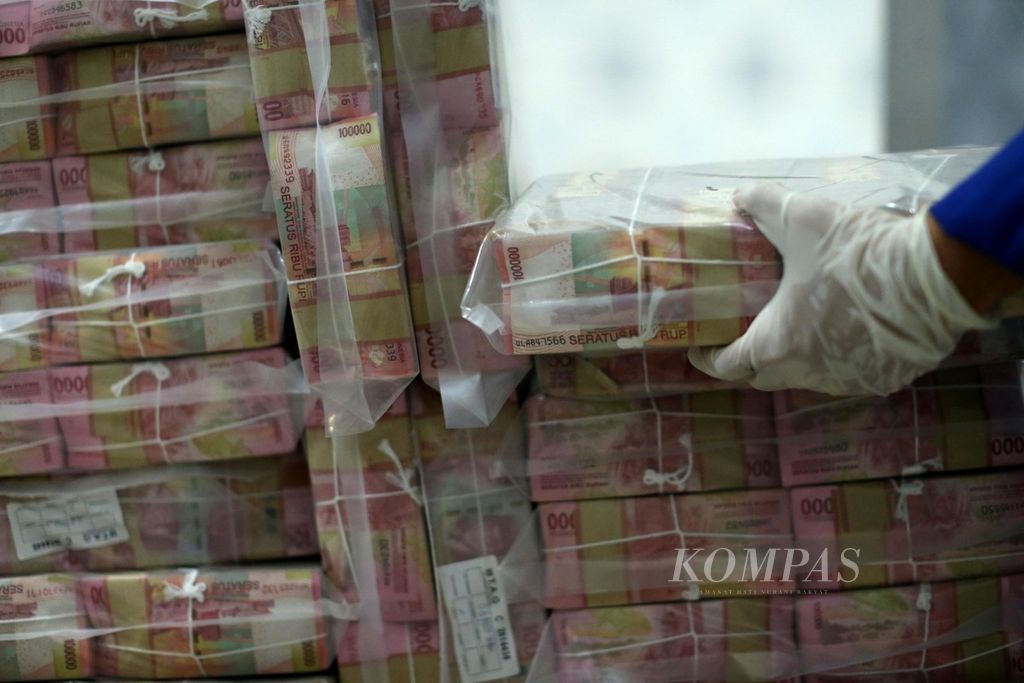 Petugas menyiapkan tumpukan uang tunai di Cash Center PT Bank Mandiri (Persero) Tbk, Jakarta, yang hendak didistribusikan ke kantor-kantor cabang, Jumat (8/5/2020). 