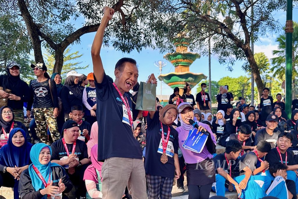 Salah seorang penyandang disabilitas mendapat hadiah saat mengikuti lari dan jalan gembira bersama Run For Equality di Mataram, Nusa Tenggara Barat, Minggu (30/7/2023) pagi.