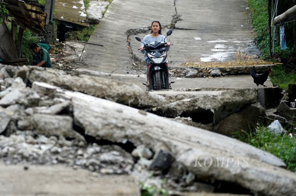 Kerusakan jalan Kampung Curug, Desa Bojong Koneng, Kecamatan Babakan Madang, Kabupaten Bogor, Jawa Barat, yang rusak akibat tanah bergerak, Rabu (21/9/2022).