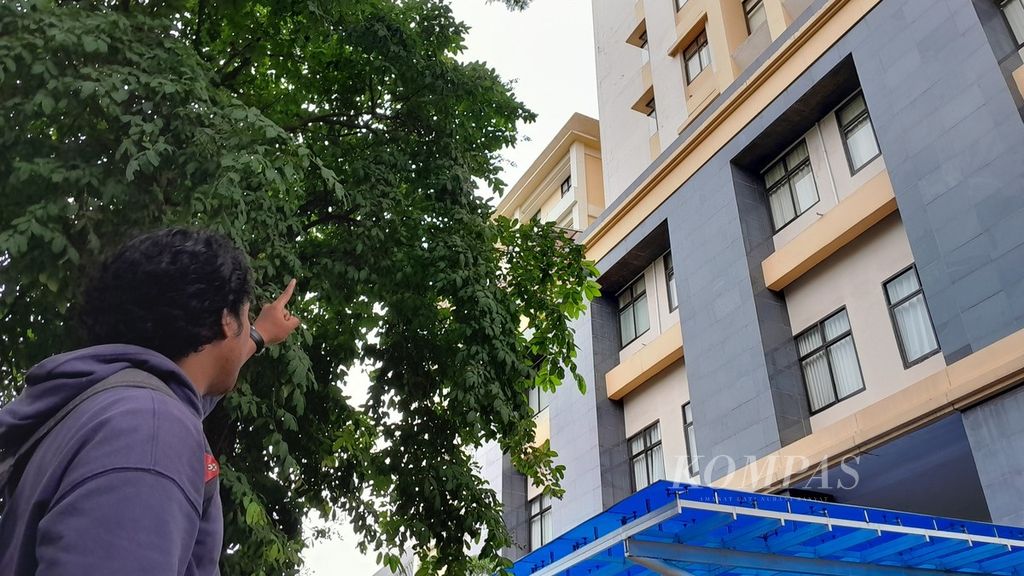 Seorang pemuda menunjuk ke lokasi di mana seorang perempuan menjatuhkan diri dari lantai 12 Gedung F Fakultas Ilmu Komputer Universitas Brawijaya, Malang, Jawa Timur, Kamis (14/12/2023).