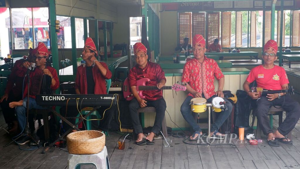 Grup musik panting menghibur pengunjung yang menikmati soto banjar dan beberapa menu lain di Rumah Makan "Soto Bang Amat" di Jalan Banua Anyar Nomor 6 Banjarmasin Timur, Kota Banjarmasin, Kalimantan Selatan, Kamis (21/12/2023). 