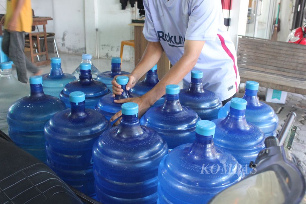 Pekerja menata air isi ulang dalam galon di salah satu depot isi ulang di Banda Aceh, Provinsi Aceh, Selasa (13/9/2022).