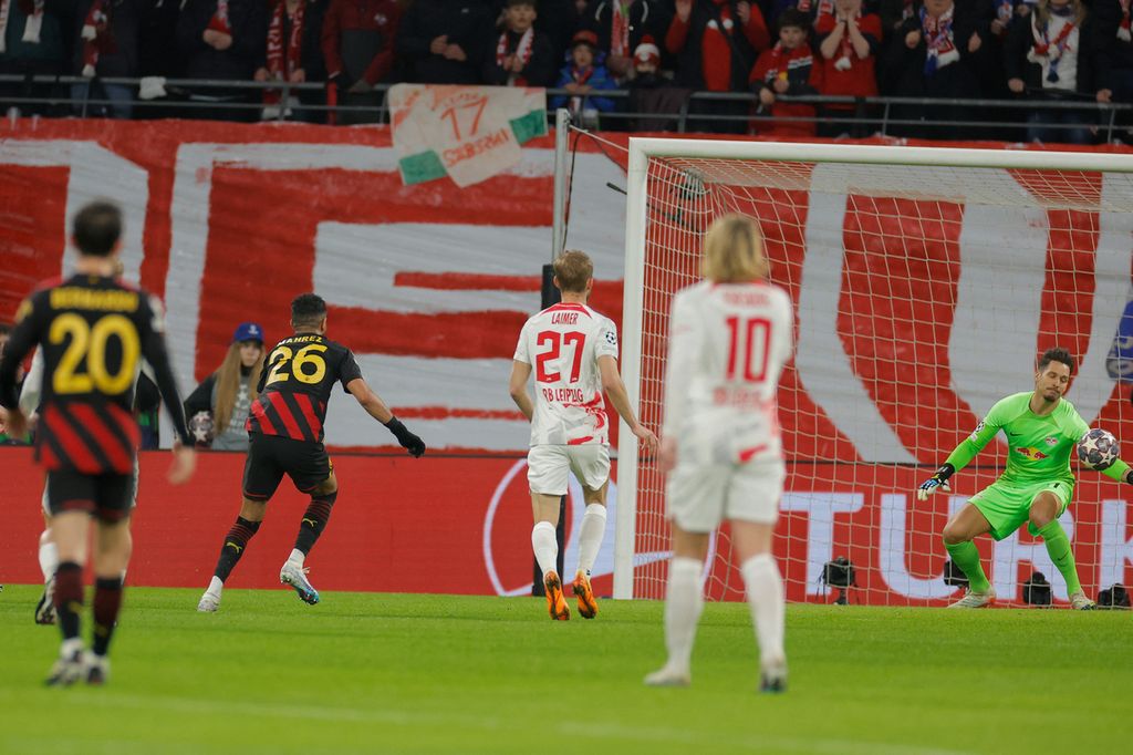 Pemain Manchester City Riyad Mahrez (kedua kiri) mencetak gol pembuka ke gawang Leipzig yang dijaga oleh Janis Blaswich (kanan) pada laga pertama babak 16 besar Liga Champions di Arena Red Bull. Leipzig, Jerman, Kamis (23/2/2023) dini hari WIB. Laga berakhir imbang 1-1.