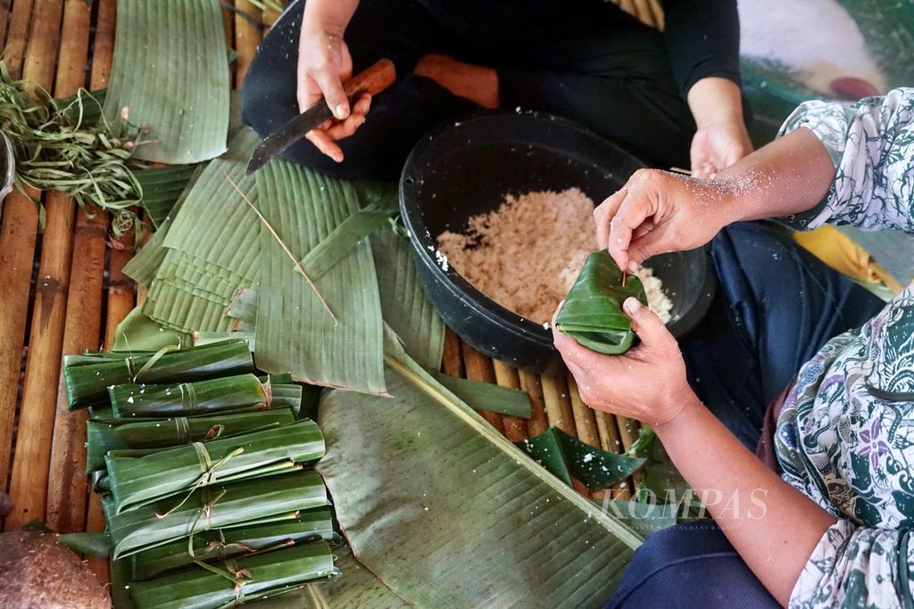 Wa Mari (42) dan Wa masrida (45) mengolah ubi, singkong, dan pisang menjadi <i>tombole</i> di Desa Pajam, Kaledupa Selatan, Wakatobi, Sulawesi Tenggara, Selasa (29/8/2023). <i>Tombole </i>adalah hasil olahan pangan lokal dengan proses bakar batu.