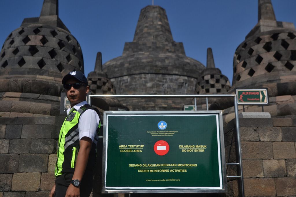 Petugas satpam melintas di dekat papan informasi larangan akses saat berkeliling untuk memperingatkan pengunjung yang menaiki stupa di lantai delapan Candi Borobudur, Magelang, Jawa Tengah, Kamis (13/2/2020). Mulai hari itu kunjungan wisatawan Candi Borobudur dibatasi hanya boleh sampai lantai delapan dan tidak boleh mencapai lantai sembilan dan sepuluh. Pembatasan dilakukan hingga waktu yang belum ditentukan untuk mengurangi dampak kerusakan candi itu akibat kunjungan wisatawan yang pernah mencapai angka empat juta wisatawan dalam setahun.