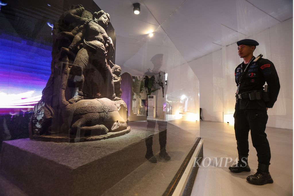 Anggota Brimob melihat arca Durga Mahisasuramardini yang dipamerkan di Galeri Nasional Indonesia, Jakarta, Senin (27/11/2023). 
