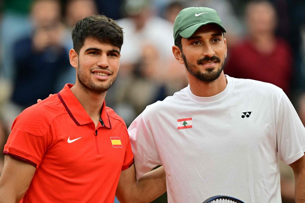 Petenis Spanyol, Carlos Alcaraz (kiri), dan petenis Lebanon, Hady Habib, berpose sebelum pertandingan babak pertama tenis Olimpiade Paris 2024 di Lapangan Suzanne Lenglen, kompleks Roland Garros, Paris, Sabtu (27/7/2024). 