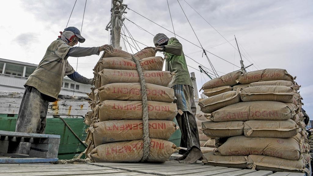 Workers load cement onto a ship at Sunda Kelapa Harbor, Jakarta, Friday (14/2/2020). The government will conduct detailed dissemination of information to people related to the job creation bill, which aims to create jobs so that it can support the country’s economy.