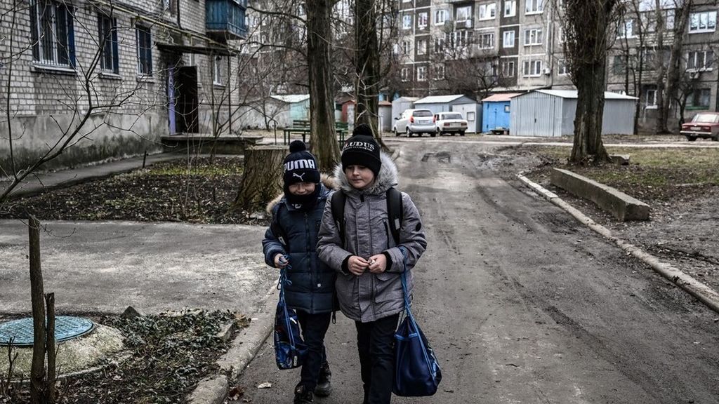  Dua anak berjalan di kota Avdiivka, Ukraina timur, Senin (21/2/2022). Ukraina pada Senin dengan tegas membantah klaim Rusia bahwa pasukan Rusia telah membunuh lima "penyabot" Ukraina yang diduga melintasi perbatasan untuk melancarkan serangan.