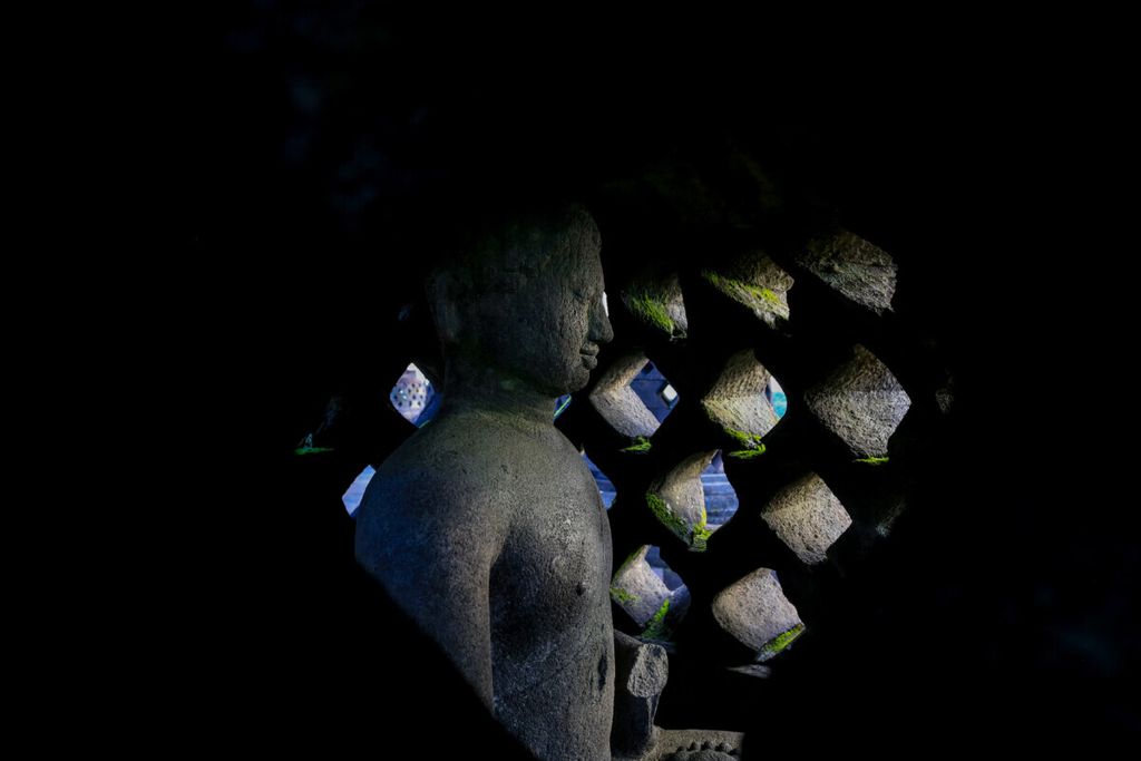 A Buddha statue in the stupa of Borobudur Temple.