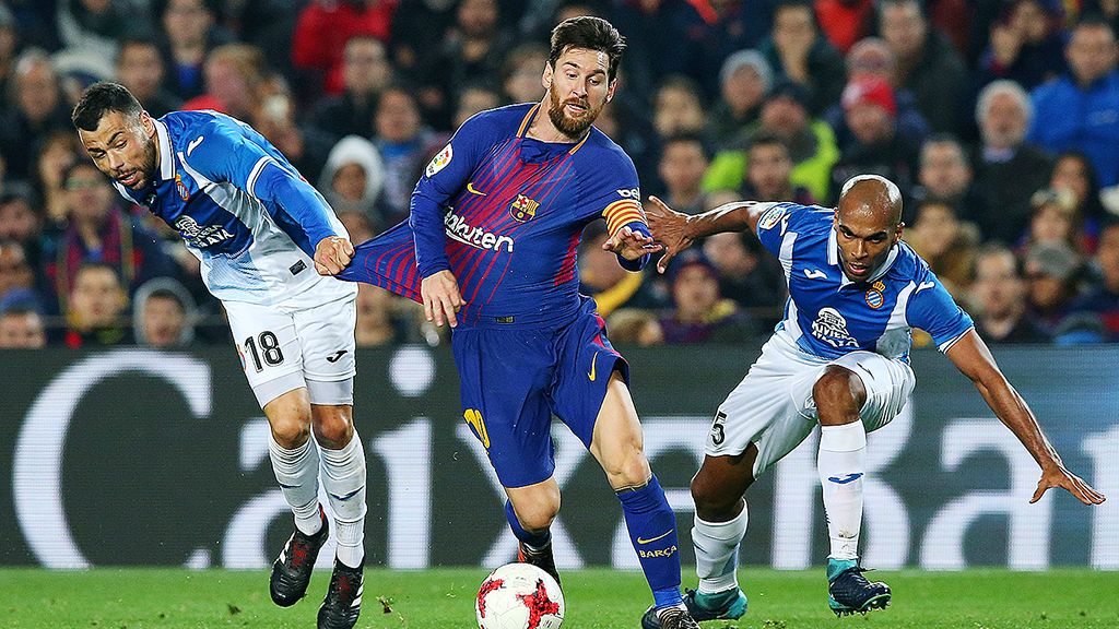 Bintang Barcelona, Lionel Messi, berusaha melewati penjagaan dua pemain Espanyol, Naldo dan Javi Fuego, pada laga kedua perempat final Piala Raja di Camp Nou, Barcelona, Kamis (25/1). Barcelona unggul 2-0. Messi mencetak gol kedua Barcelona, yang sekaligus menjadi gol ke-4.000 Barcelona di Camp Nou pada laga resmi. 