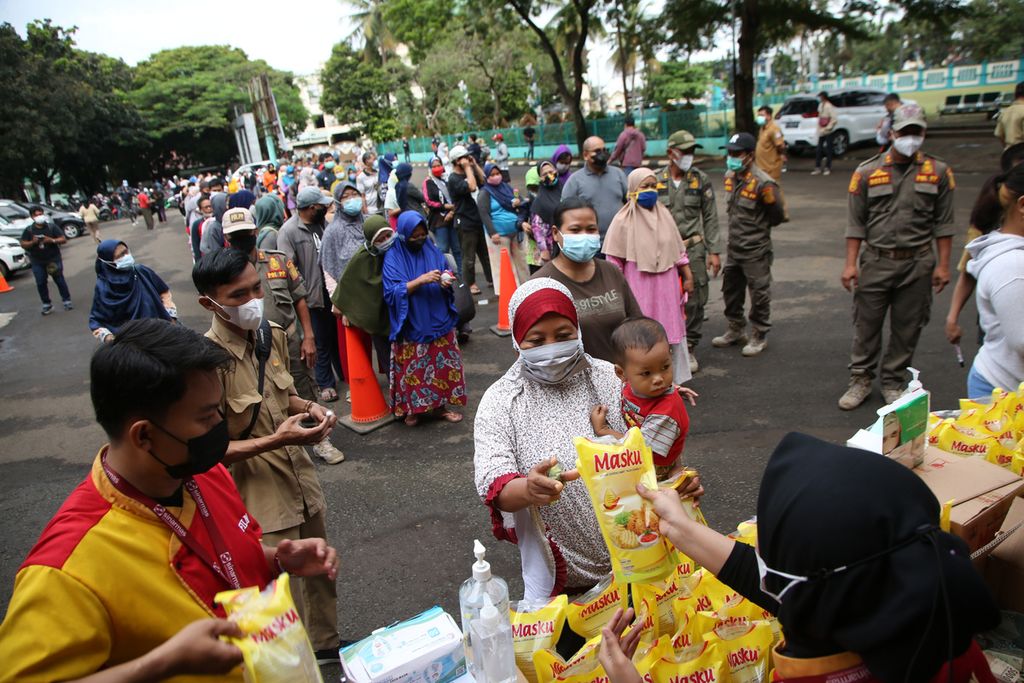 Ratusan orang mengantre membeli minyak goreng saat operasi pasar minyak goreng di kantor Kecamatan Pamulang, Tangerang Selatan, Banten, Selasa (11/1/2022). Sebanyak 4.000 liter minyak goreng yang dijual Rp 14.000 per liter disiapkan dalam operasi pasar ini. 